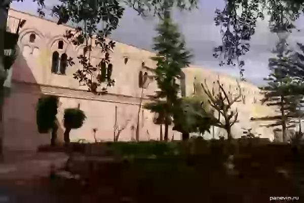 Wall of a monastery and trees in park