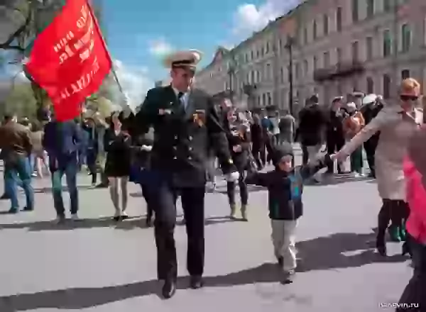 Naval officer with a family and the Victory flag