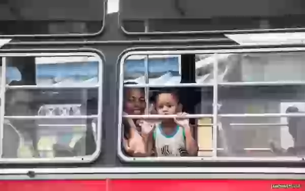 People in a bus window