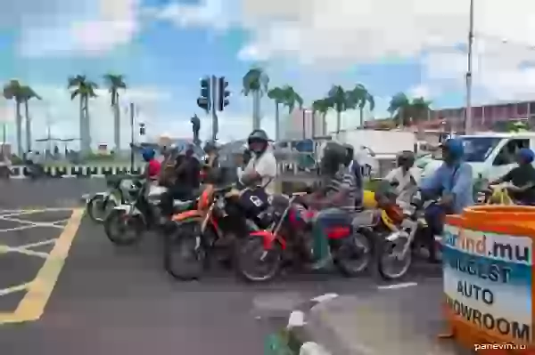 Motorcyclists before a traffic light