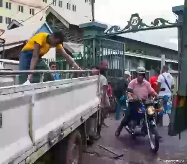 Goods unloading before collars of the city market