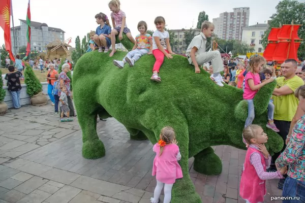Children on a green rhinoceros