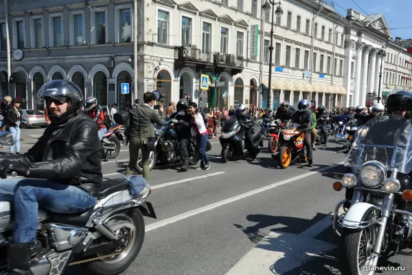 Spectators are photographed with the motorcyclist