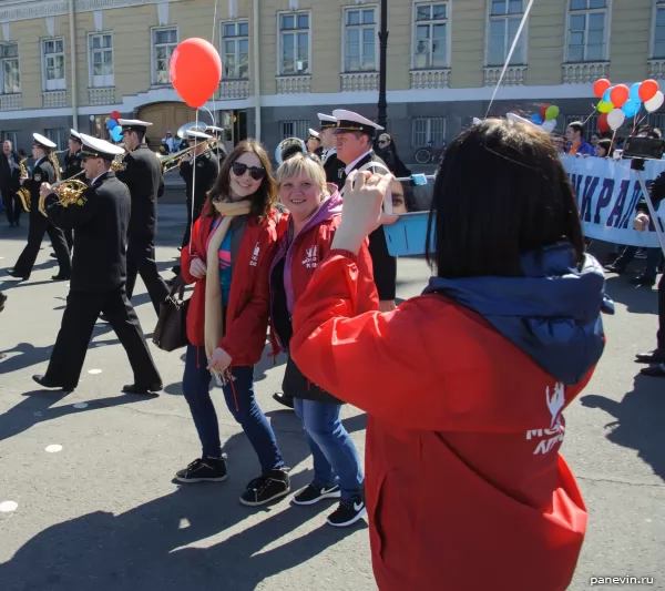 Girls are photographed against military seamen