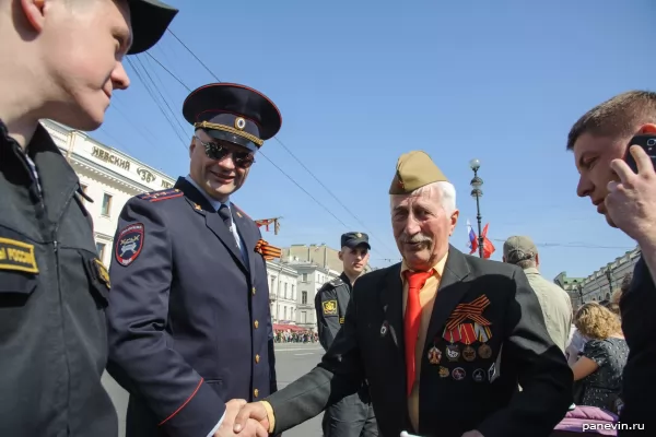 Grandfather-guardsman greets a police cordon