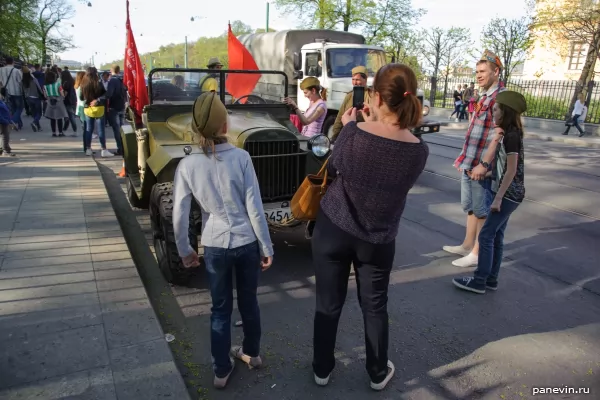 Girls photograph a jeep