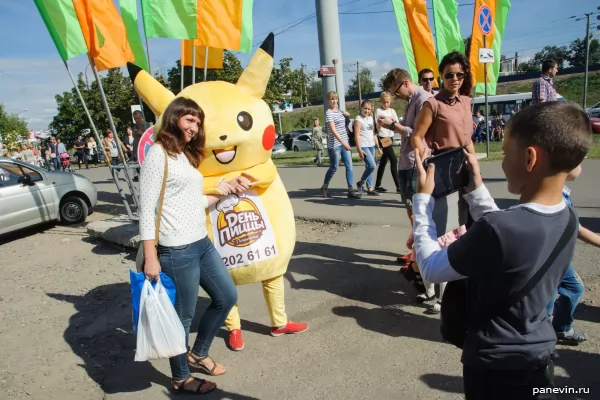 Girl is photographed with pokemon Pikachu