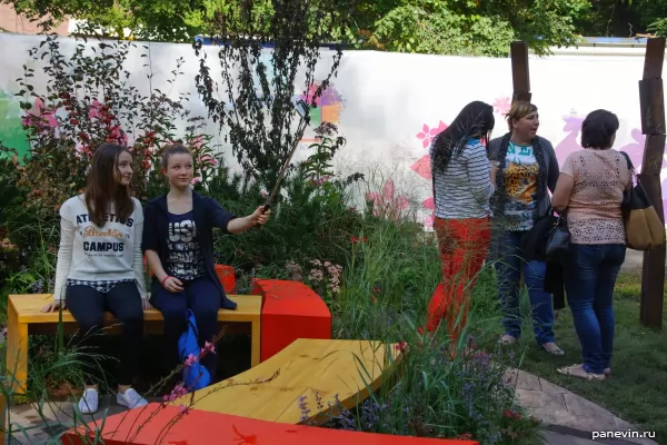 Girls made selfie against a tops of vegetable