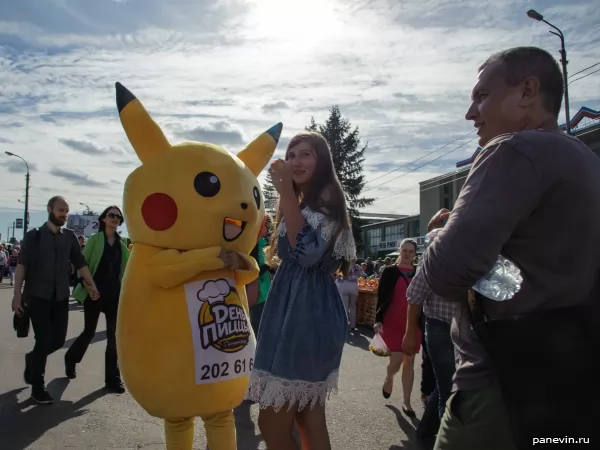 Girl is photographed with pokemon Pikachu