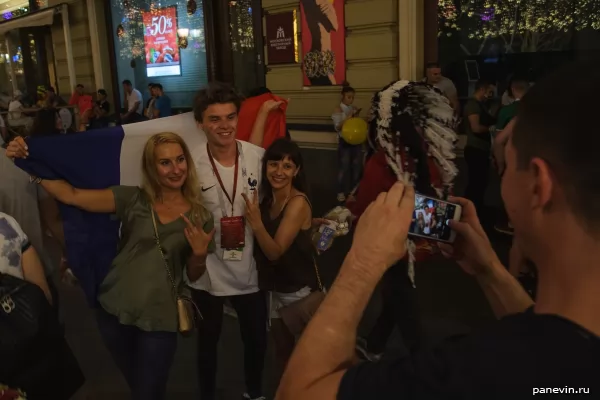 Girls take pictures with a French fan