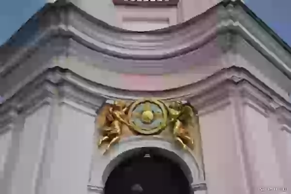 Angels holding the insignia of the Order of St. Andrew the First-Called over the entrance to the cathedral