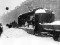 Погрузка сколотого льда на грузовой трамвай на проспекте 25 Октября, 11 марта 1942, автор съемки Коновалов Г