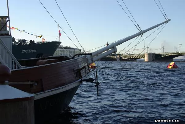 Different eras. The bow of a sailboat and a modern ship