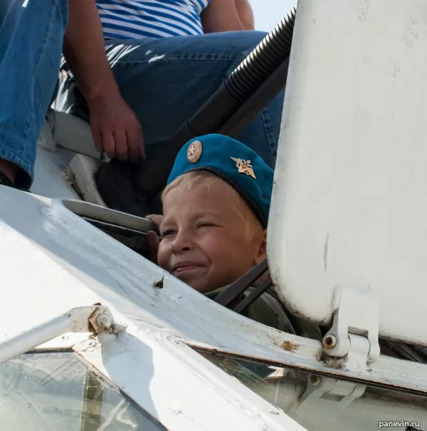 Boy in the armored troop-carrier hatch