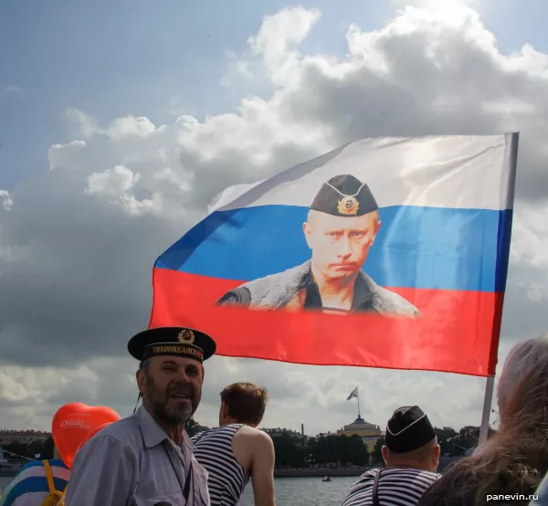 Seamen with a flag of Russia with Putin's portrait, Navy Day