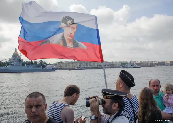 Seamen with a flag of Russia with Putin's portrait