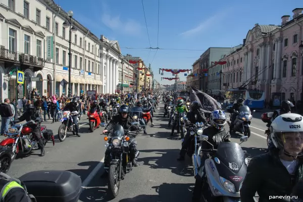 Column of bikers on Nevsky avenue, view towards Gostiny Dvor from the Green bridge