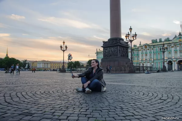 A young lady drinks a selfie