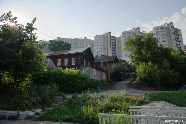 Old wooden houses in the foreground and new buildings in the back